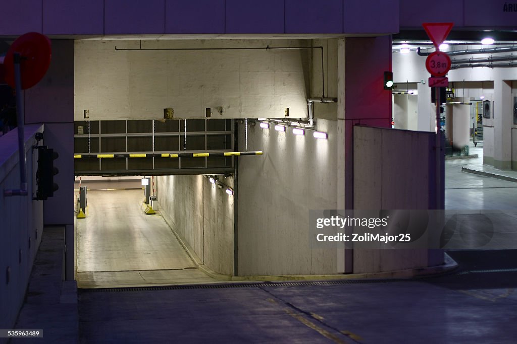 Underground garage entrance with lights inside at night