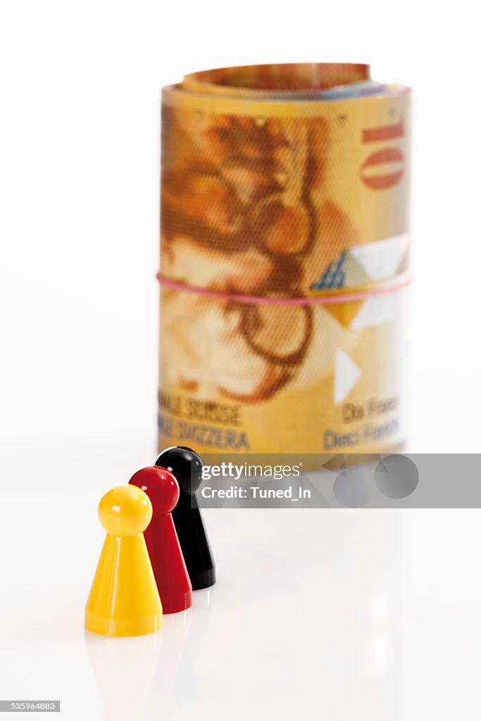 Multi coloured  tokens with swiss francs in background