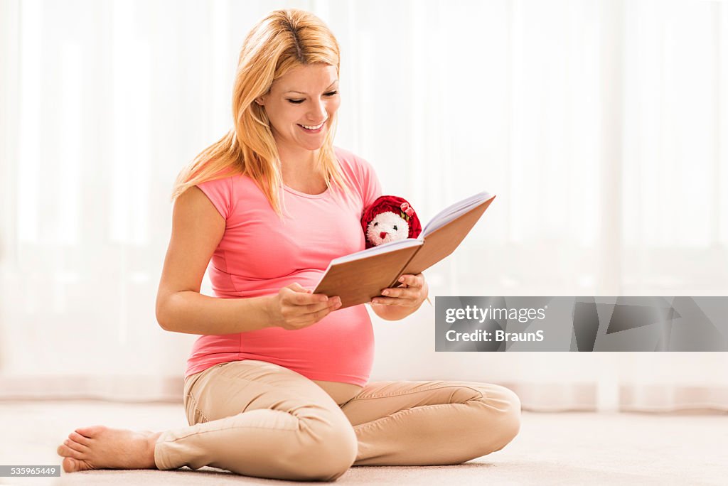 Pregnant woman reading a book.