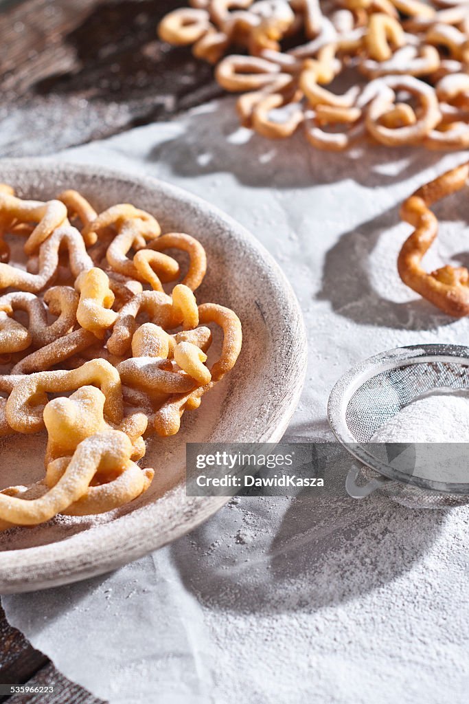 Sweet crisp pastry deep fried and sprinkled with powdered sugar.