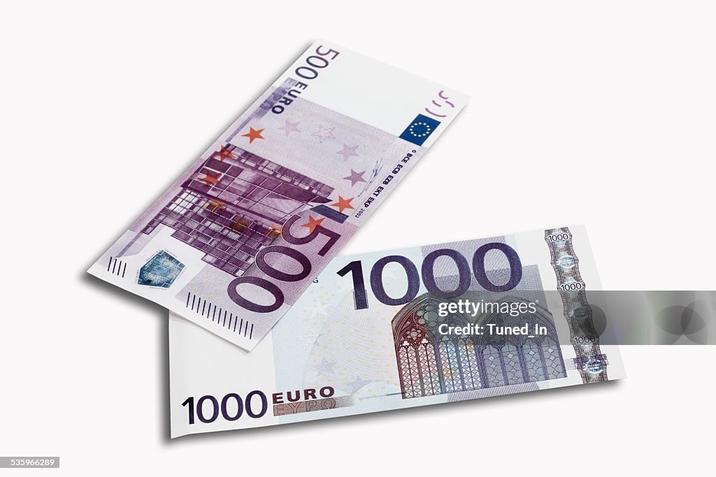 500 and 1000 Euro notes on white background, close-up