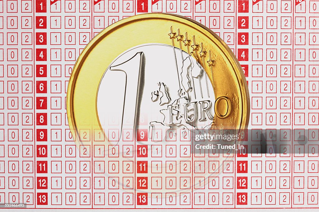 Close up of 1 euro coin on betting slip