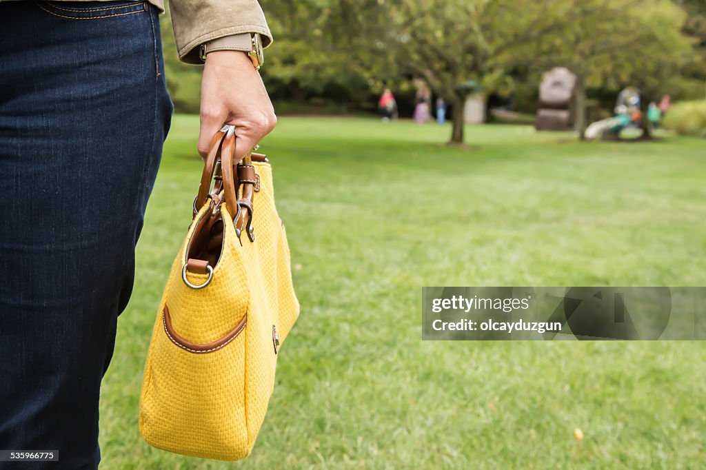 Holding yellow purse