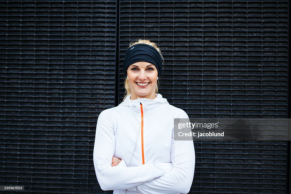 Young woman in sportswear looking at camera smiling