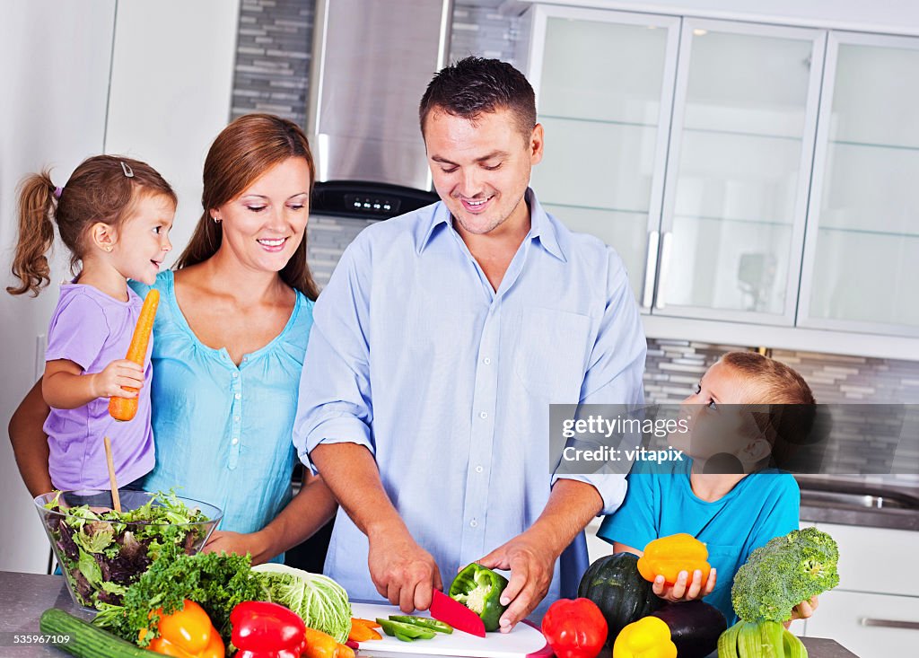 Happy family making dinner together in the kitchen