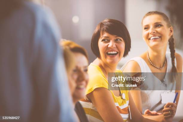 laughing women on seminar - talking close up business stockfoto's en -beelden