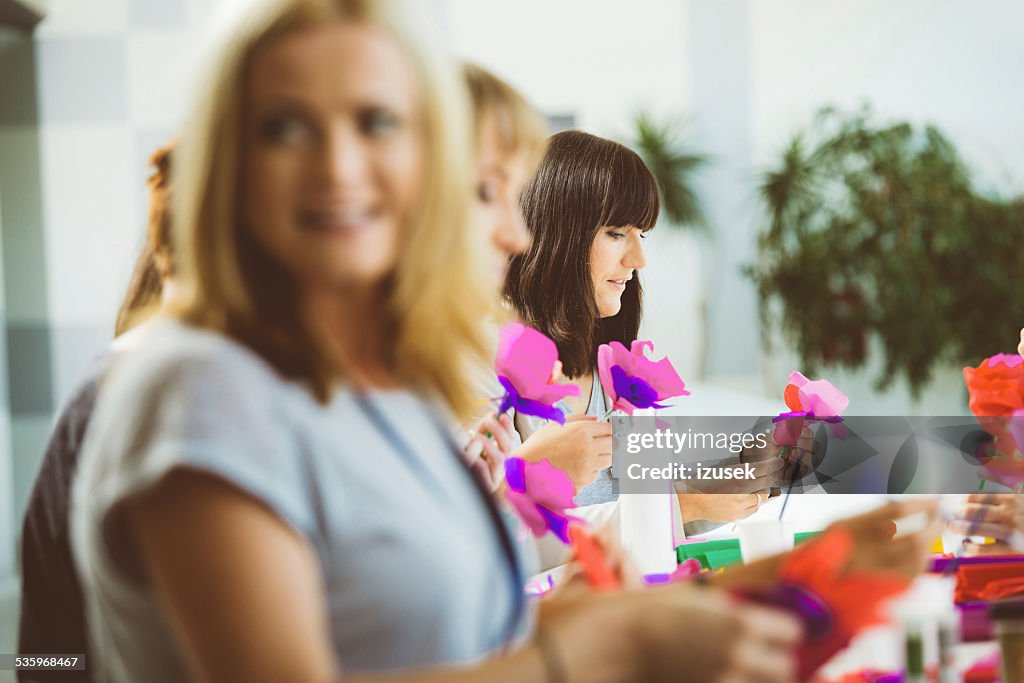 Group of women making paper flowers