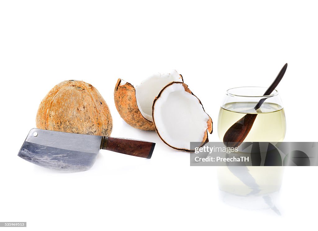 Coconut oil with big knife and piece of coconut