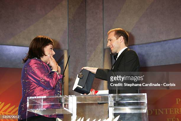 Actor Ralph Fiennes presents actress Hanna Laslo with her award for "Best Female Actress" at the closing ceremony of the 58th Cannes Film Festival.