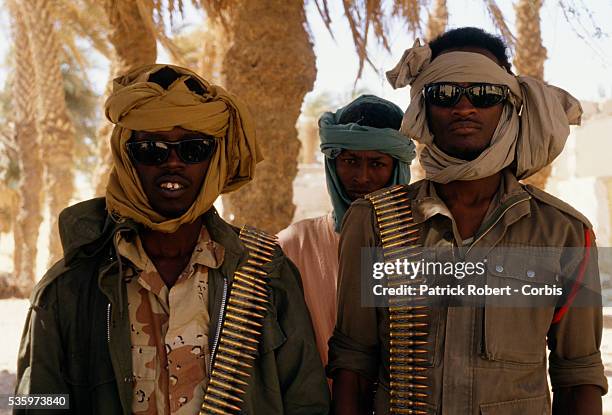 Armed with bandoliers, young soldiers with the Forces Armees Nationales Chadiennes , or National Army of Chad, guard their post in Faya-Largeau with...