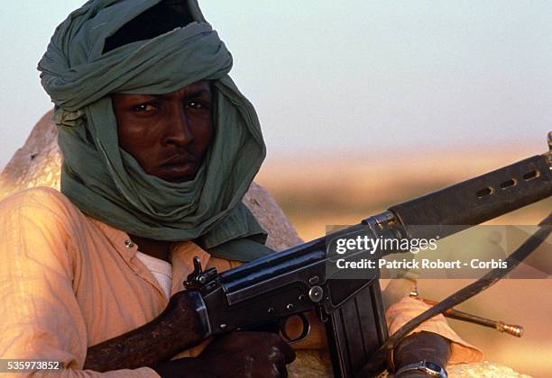 Young soldier with the Forces Armees Nationales Chadiennes , or National Army of Chad, guards his post in Faya-Largeau with a machine gun. The FANT...