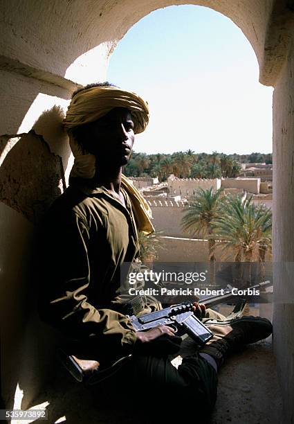 Young soldier with the Forces Armees Nationales Chadiennes , or National Army of Chad, guards his post in Faya-Largeau with a machine gun. The FANT...