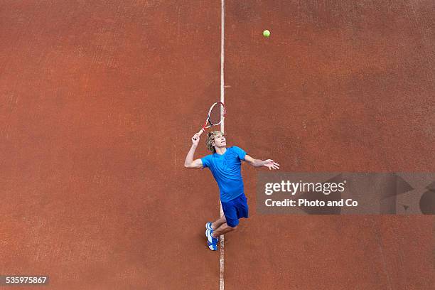 player serving the ball on clay court tennis - tennis championship stock pictures, royalty-free photos & images