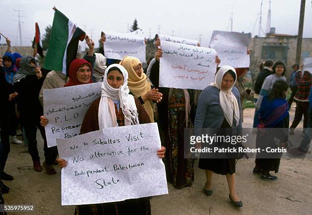 Palestinian women demonstrators carry signs during a protest in Ramallah. Violence broke out after rebel Israeli and Palestinian fighters protested...