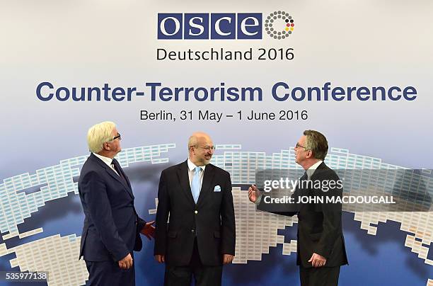 German Foreign Minister Frank-Walter Steinmeier, OSCE Secretary General Lamberto Zannier, and German Interior Minister Thomas de Maiziere pose for...