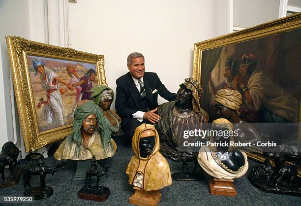 Algerian businessman Djillali Mehri poses with a collection of sculpture busts, sculptures of camels, and paintings in Paris. Mehri is opening an art...