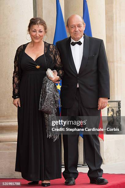 French Minister of defence Jean-Yves Le Drian and his wife arrive at the Elysee Palace for a State dinner in honor of Queen Elizabeth II, hosted by...