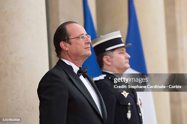 French President Francois Hollande welcomes Queen Elizabeth II at the Elysee Palace for a State dinner in honor of Queen Elizabeth II, hosted by...