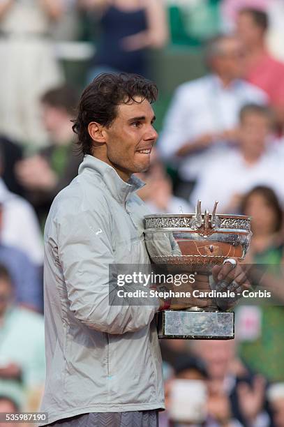 Rafael Nadal of Spain celebrates with the Coupe de Mousquetaires after victory in his men's singles final match against Novak Djokovic of Serbia on...