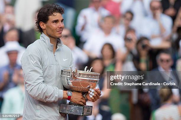 Rafael Nadal of Spain celebrates with the Coupe de Mousquetaires after victory in his men's singles final match against Novak Djokovic of Serbia on...