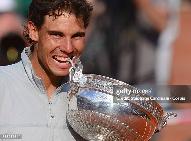 Rafael Nadal of Spain celebrates with the Coupe de Mousquetaires after victory in his men's singles final match against Novak Djokovic of Serbia on...