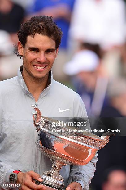 Rafael Nadal of Spain celebrates with the Coupe de Mousquetaires after victory in his men's singles final match against Novak Djokovic of Serbia on...