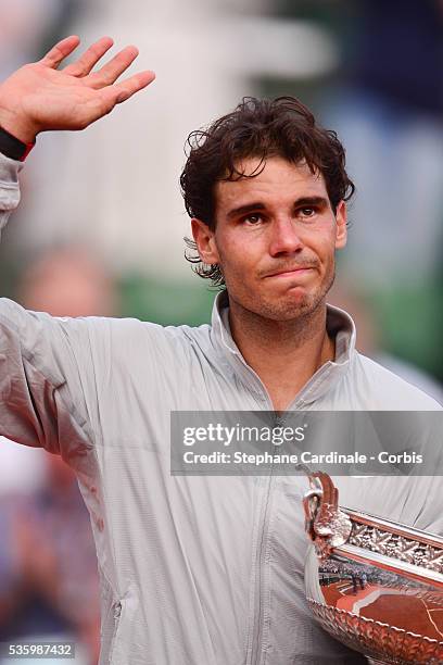 Rafael Nadal of Spain celebrates with the Coupe de Mousquetaires after victory in his men's singles final match against Novak Djokovic of Serbia on...