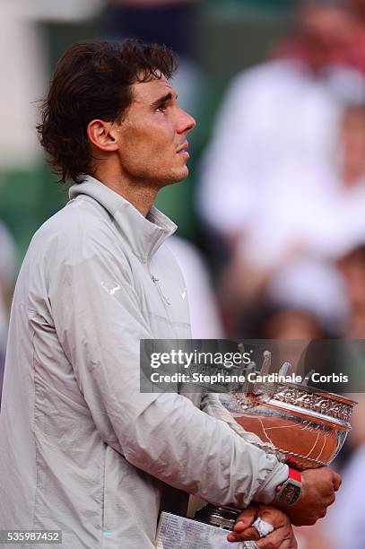 Rafael Nadal of Spain celebrates with the Coupe de Mousquetaires after victory in his men's singles final match against Novak Djokovic of Serbia on...