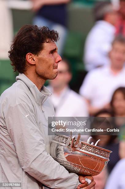 Rafael Nadal of Spain celebrates with the Coupe de Mousquetaires after victory in his men's singles final match against Novak Djokovic of Serbia on...