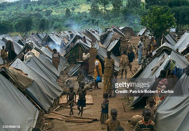 Refugees walk among the tents in a refugee camp for Tutsis near Kirundo in northern Burundi. The camp was created for refugees entering the country...
