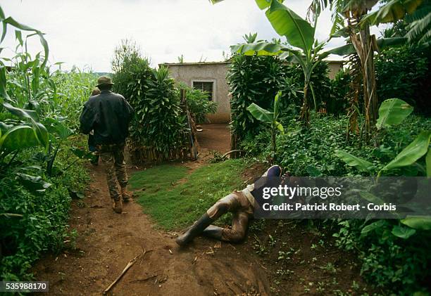 The rebels of the Rwandan Patriotic Front pass through the village where the population has been massacred. | Location: Nyanza Hill, Rwanda.