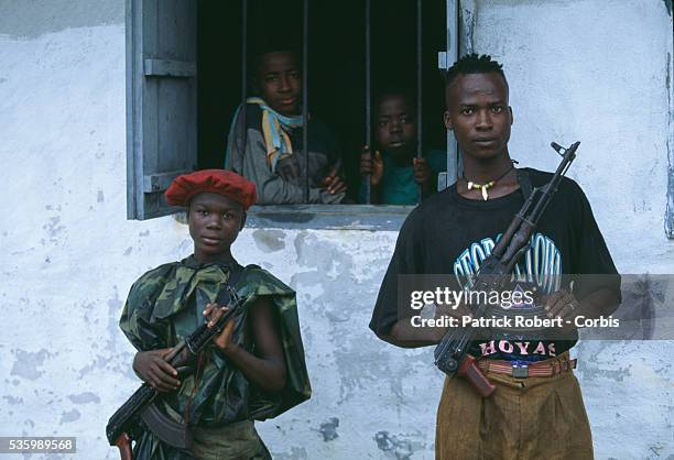 Two young Liberia Peace Council recruits stand with their assault rifles at a training facility at Padhore Davis, Liberia. The Liberia Peace Council...