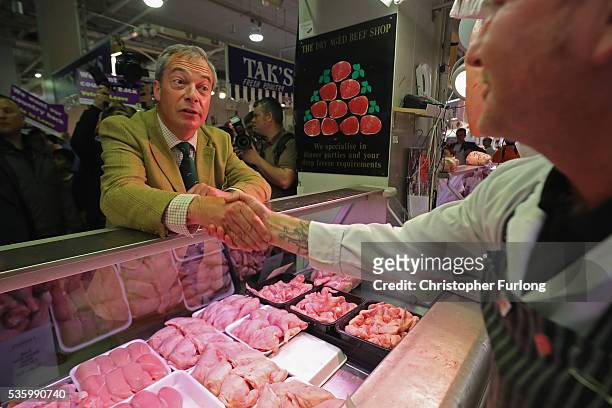 Leader of the United Kingdom Independence Party , Nigel Farage talks to supporters and market traders in Birmingham Rag Market during campaigning for...