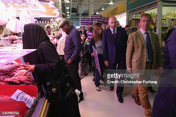 Leader of the United Kingdom Independence Party , Nigel Farage talks to supporters and market traders in Birmingham Rag Market during campaigning for...