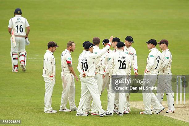 Lancashire celebrate the as Tim Bresnan of Yorkshire walks off the pitch after a dramatic umpire call during day three of the Specsavers County...