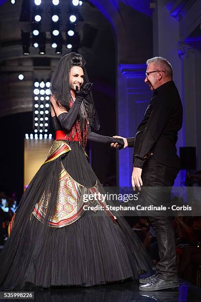 Conchita Wurst and Jean Paul Gaultier on the runway at the Jean Paul Gaultier show during the Paris Fashion Week - Haute Couture Fall/Winter 2014-2015