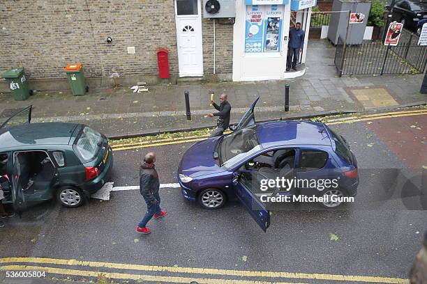 Two men, brandishing an axe and a knife, threaten each other in the street in Stratford on May 31, 2016 in London, England. The altercation happened...