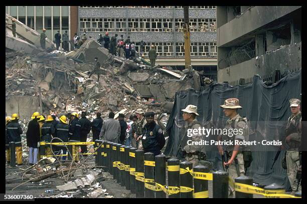 Soldiers on guard in front of the embassy while rescue workers continue their search.