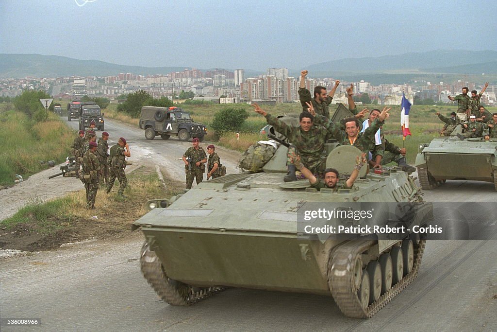 SERB TROOPS WITHDRAW AND KFOR TROOPS ARRIVE.