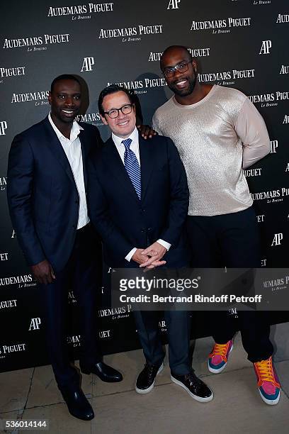 Omar Sy, CEO of Audemars Piguet Francois Henry Bennahmias and Judoka Teddy Riner attend the Audemars Piguet Rue Royale Boutique Opening on May 26,...