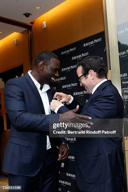 Actor Omar Sy and CEO of Audemars Piguet Francois Henry Bennahmias attends the Audemars Piguet Rue Royale Boutique Opening on May 26, 2016 in Paris,...