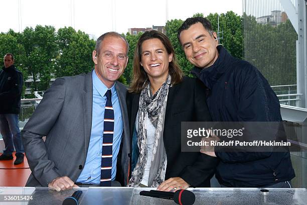 Director of Roland Garros tournament, Guy Forget, Presenter of Roland garros Amelie Mauresmo and Sports journalist Laurent Luyat pose at France...