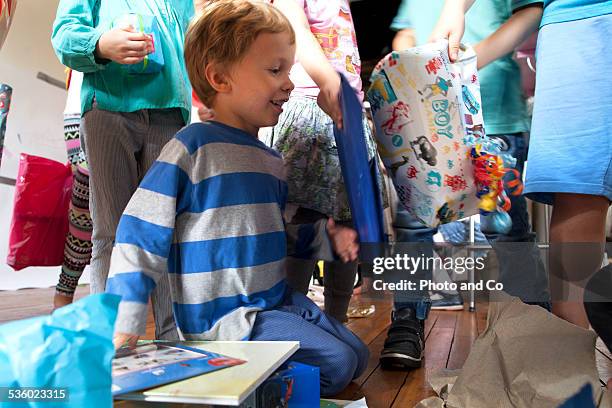 child receiving gifts on his birthday - birthday gift stock pictures, royalty-free photos & images