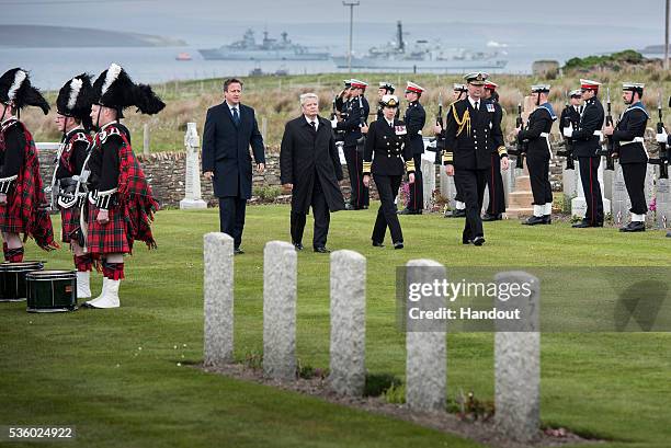 In this handout photo provided by the German Government Press Office , German President Joachim Gauck , British Prime Minister David Cameron and...