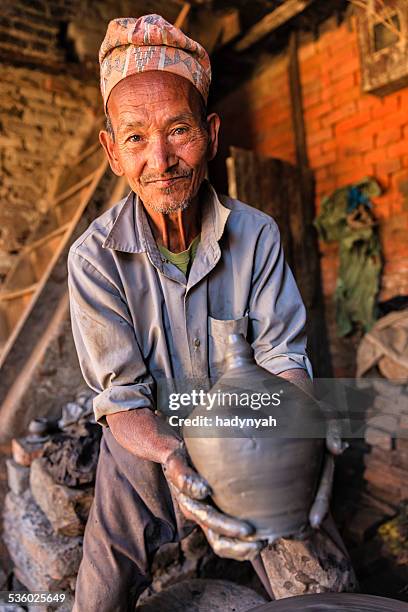 nepalese potter working in bhaktapur - nepal culture stock pictures, royalty-free photos & images