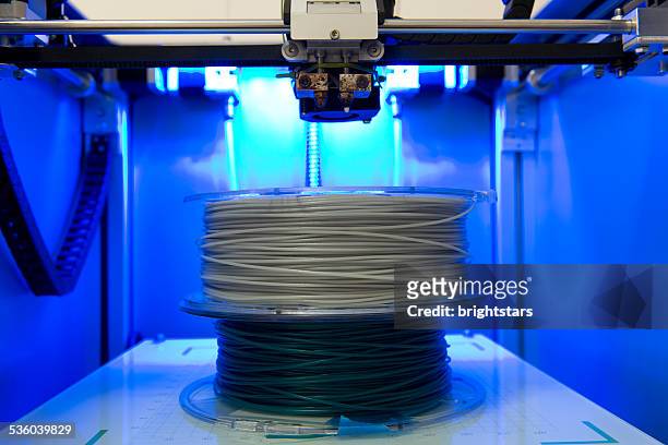 filament rolls in a 3d printer - filamento fotografías e imágenes de stock