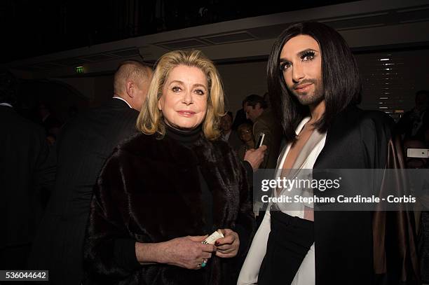 Catherine Deneuve and Conchita Wurst attend the Jean Paul Gaultier show as part of Paris Fashion Week Haute Couture Spring/Summer 2015 on January 28,...