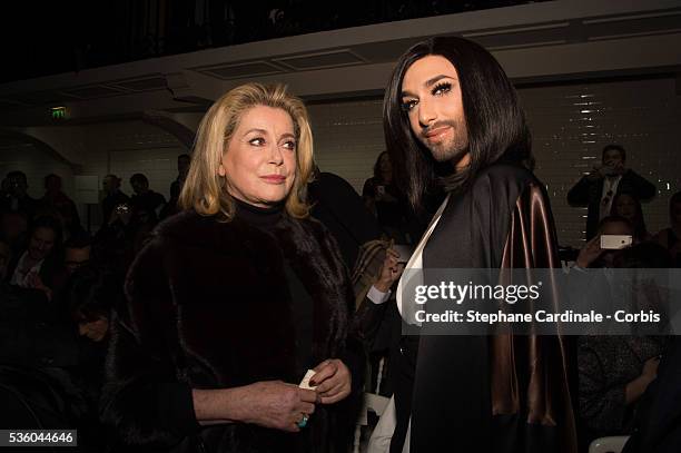 Catherine Deneuve and Conchita Wurst attend the Jean Paul Gaultier show as part of Paris Fashion Week Haute Couture Spring/Summer 2015 on January 28,...