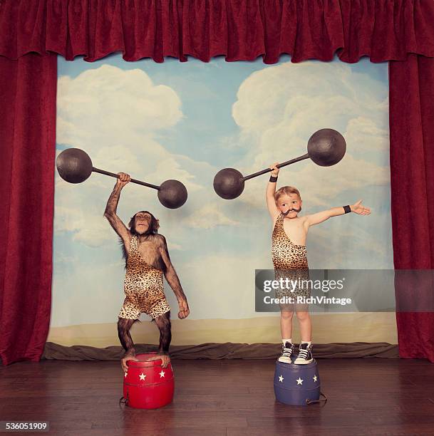 young boy and chimp friend in the circus - young kid and barbell stock pictures, royalty-free photos & images