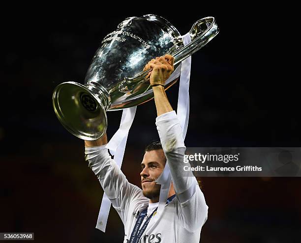 Gareth Bale of Real Madrid celebrates with the trophy after victory in the UEFA Champions League Final match between Real Madrid and Club Atletico de...